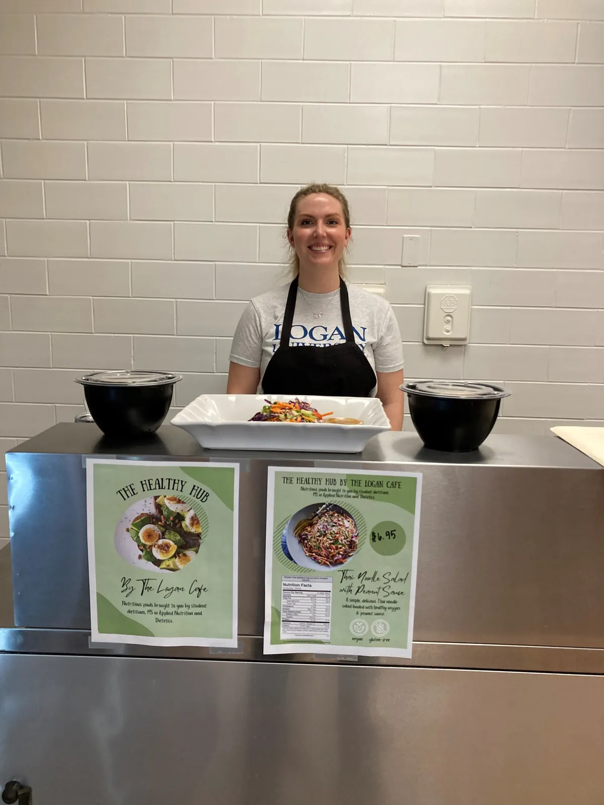 An MS-AND student stands behind the Healthy Hub in the Logan Café