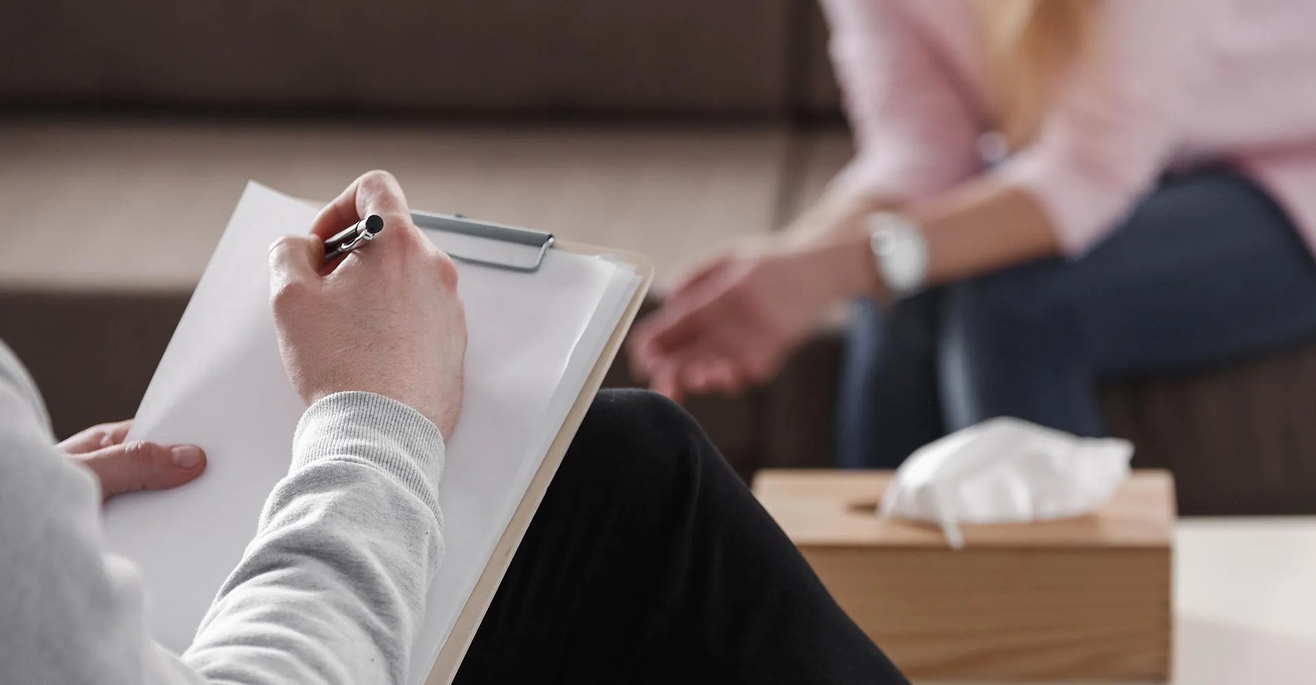 Counselor taking notes during a one-on-one session