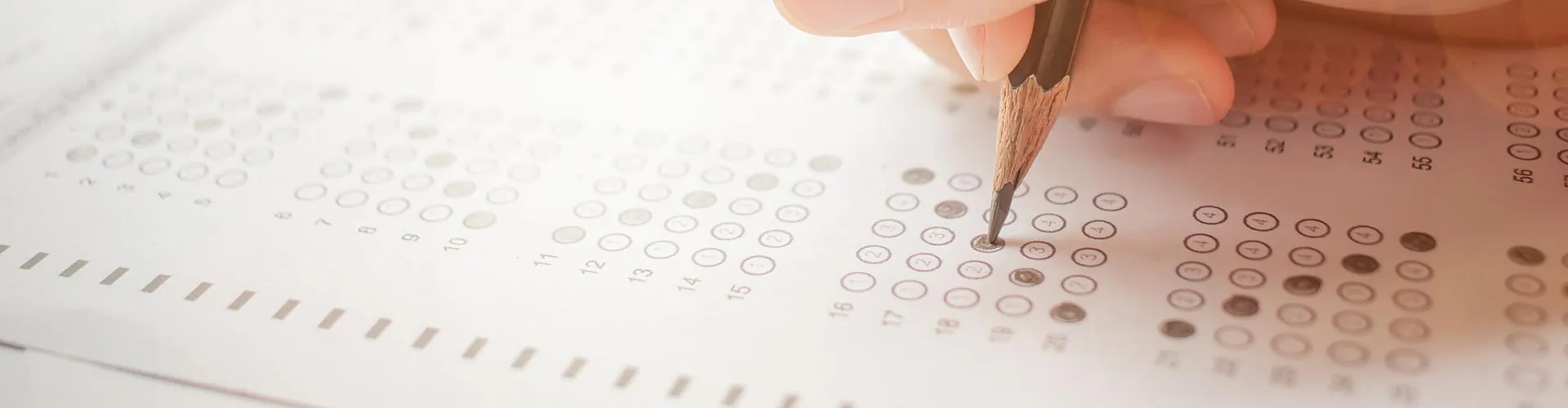Pencil filling in an answer sheet during an exam
