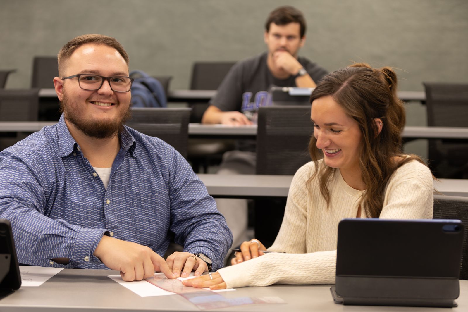 Two students share a laugh during class at Logan