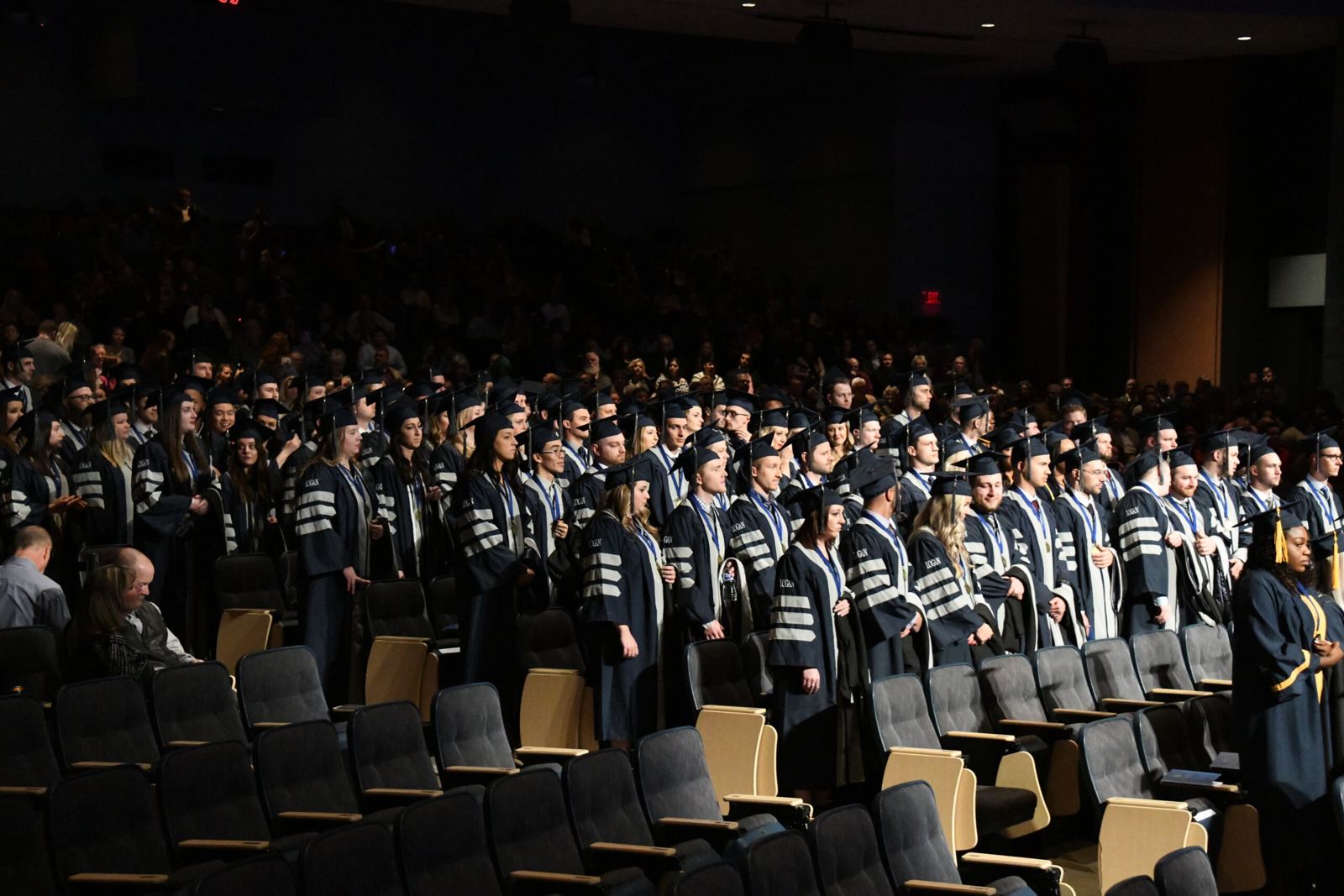 Logan University graduates standing in caps and gowns at commencement