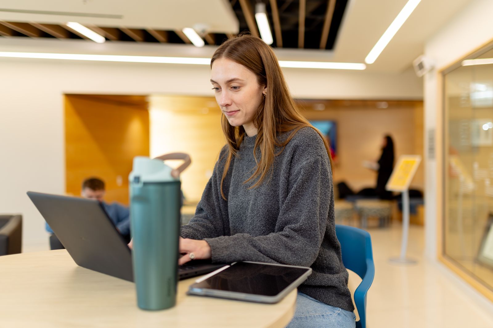 A student works on a laptop in a Logan study area