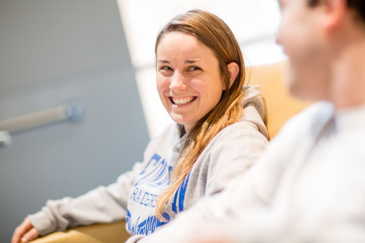A smiling Logan University student in class