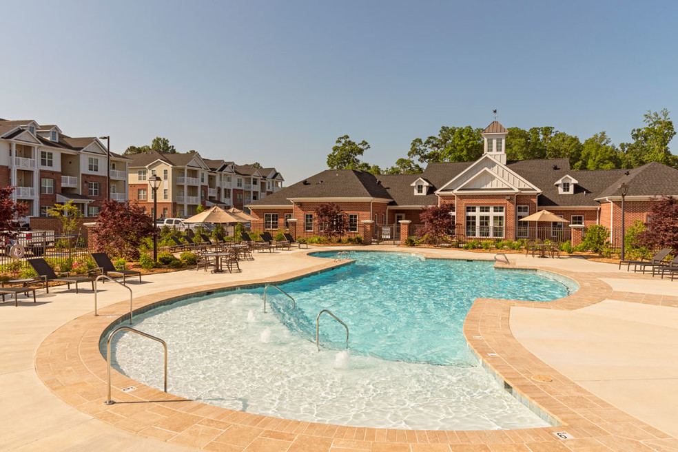 Pool and clubhouse at an apartment community near Logan University