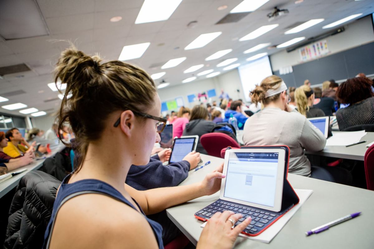 Logan University students taking notes on tablets during a lecture