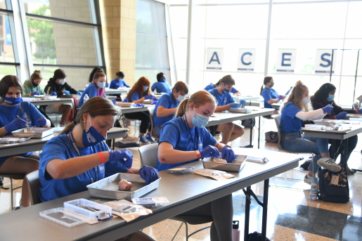 High school students learn about suturing at Logan University's fourth annual Anatomy Centered Education and Science Workshop