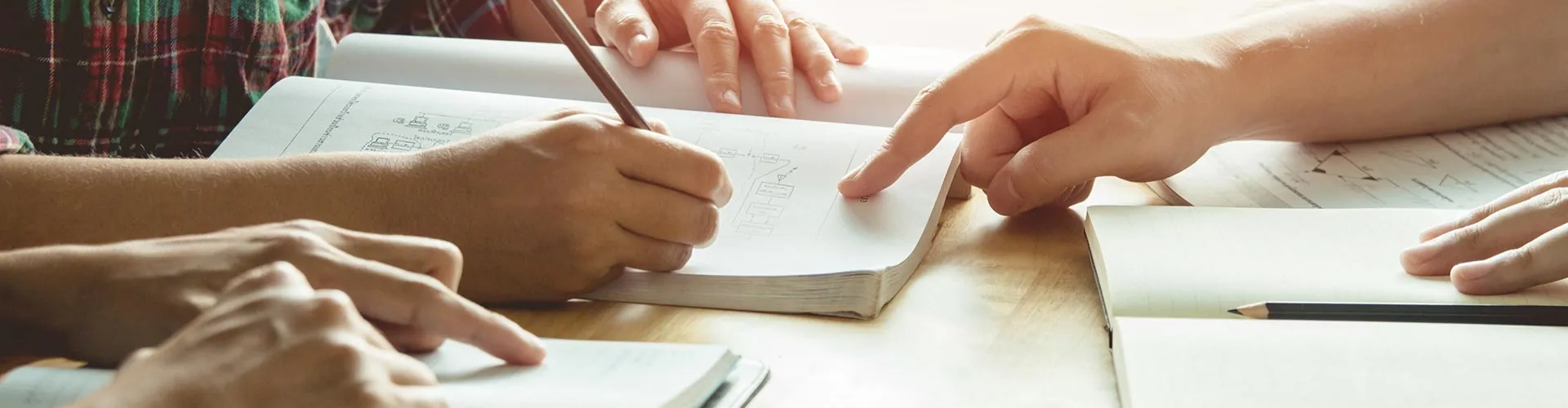 Two students working through notes together at a table