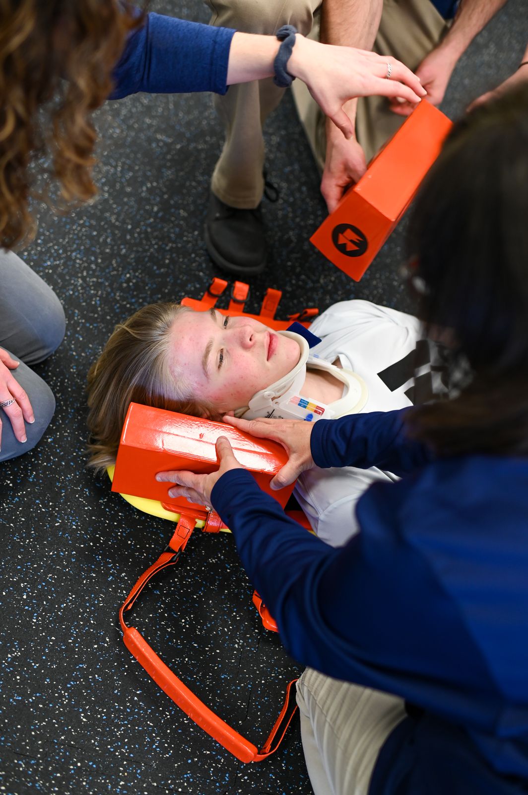 Students practicing sports rehabilitation techniques in a Logan lab