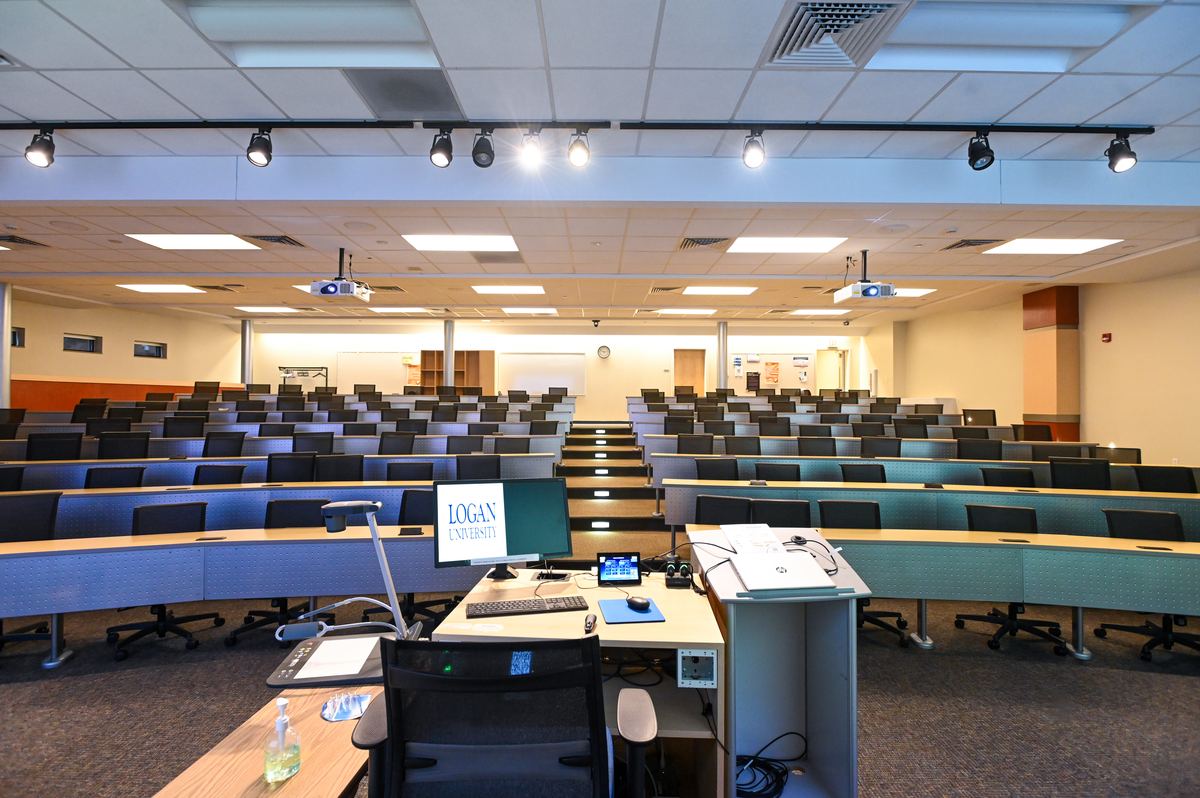 Classroom G134 seen from the front centre, projection screens above the teaching wall