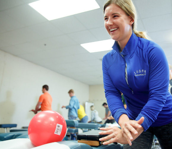 Student smiling and practicing within a class