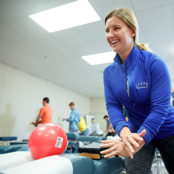 Student smiling and practicing within a class