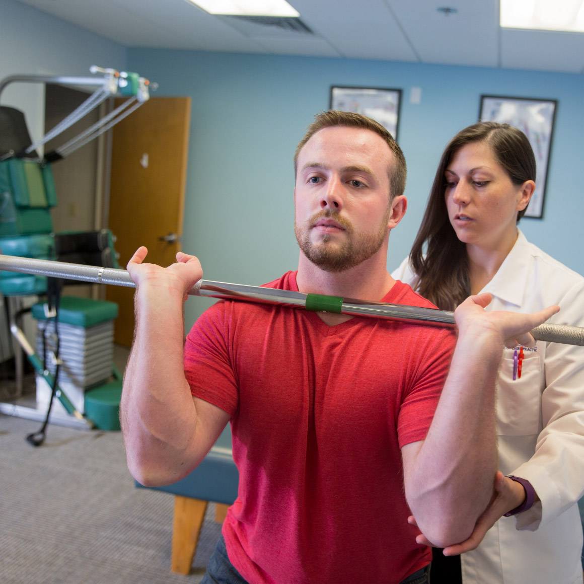 Student lifting weights with assistance