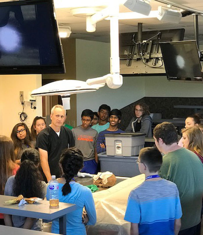 Instructor teaching in cadaver lab.