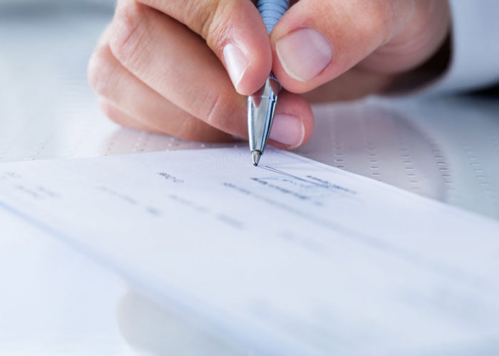 Hand writing a check.
