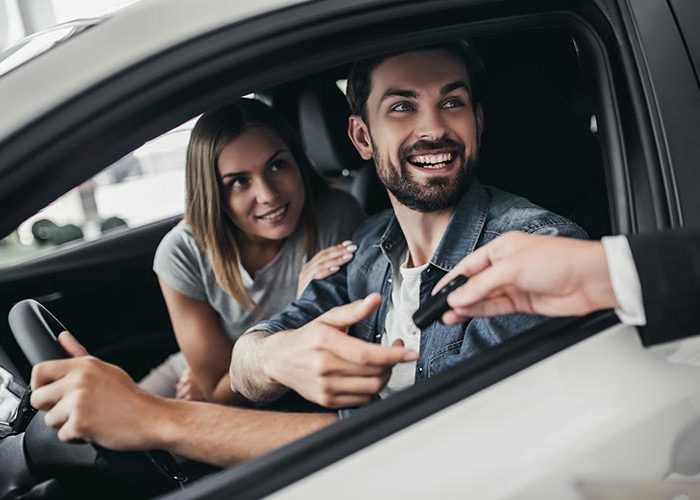 Man and woman renting a car.