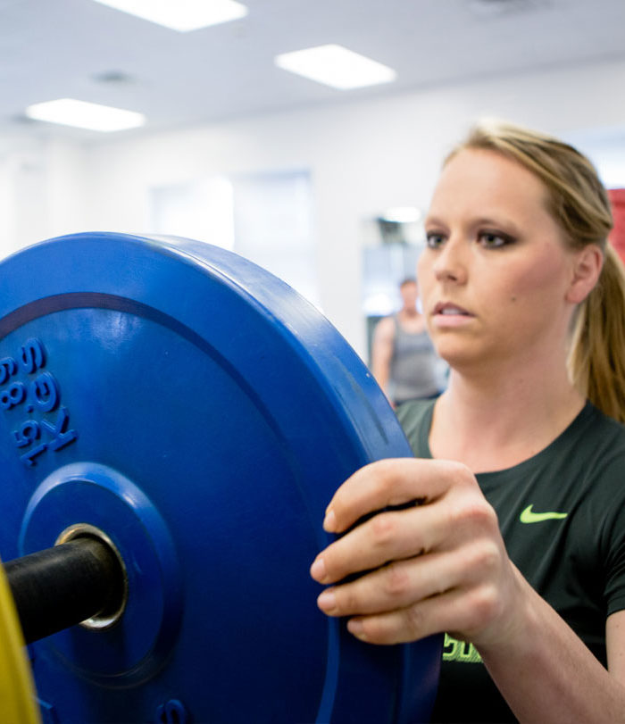 Female working out in the wellness center.