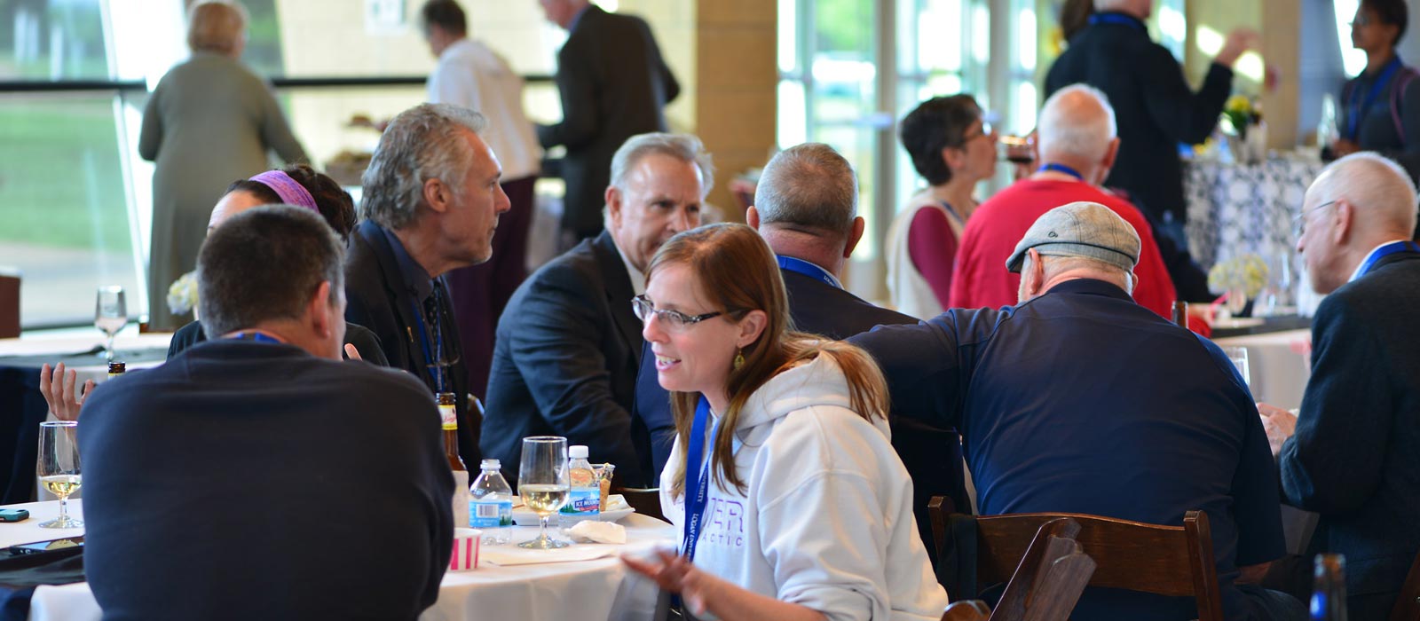 corporate-event-full-width Group socializing at Logan event.