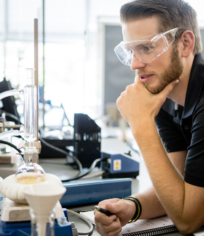 Student in lab, studying.