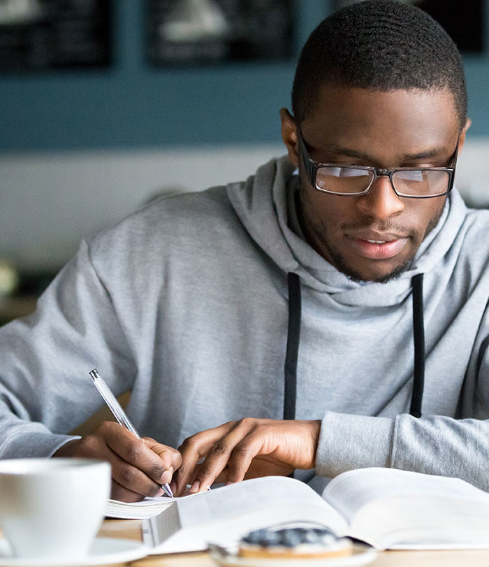 Male student reading a book.