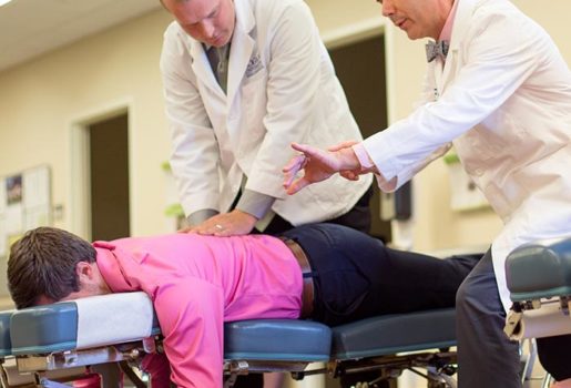 Instructor teaching how to adjust patient.