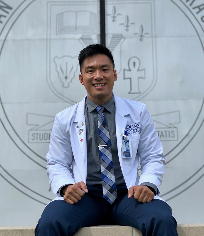 Male student smiling on campus.