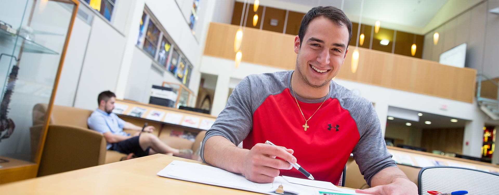 student-success-full-width Male student in library studying.