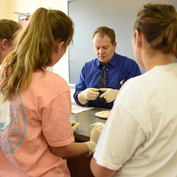 Students in cadaver lab with instructor.