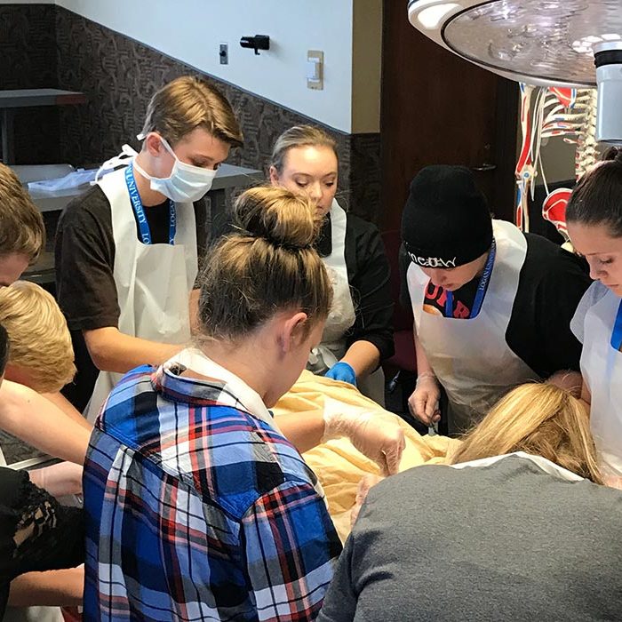 Students in cadaver lab with instructor.