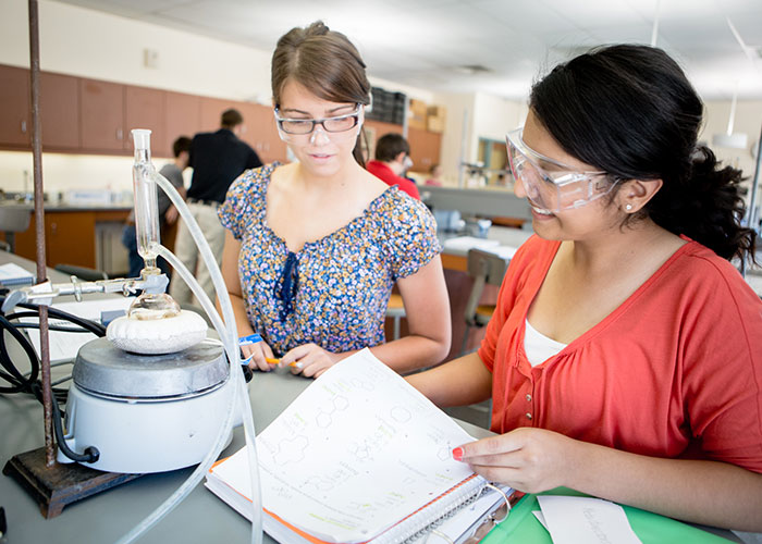 Two female students working together in science lab.