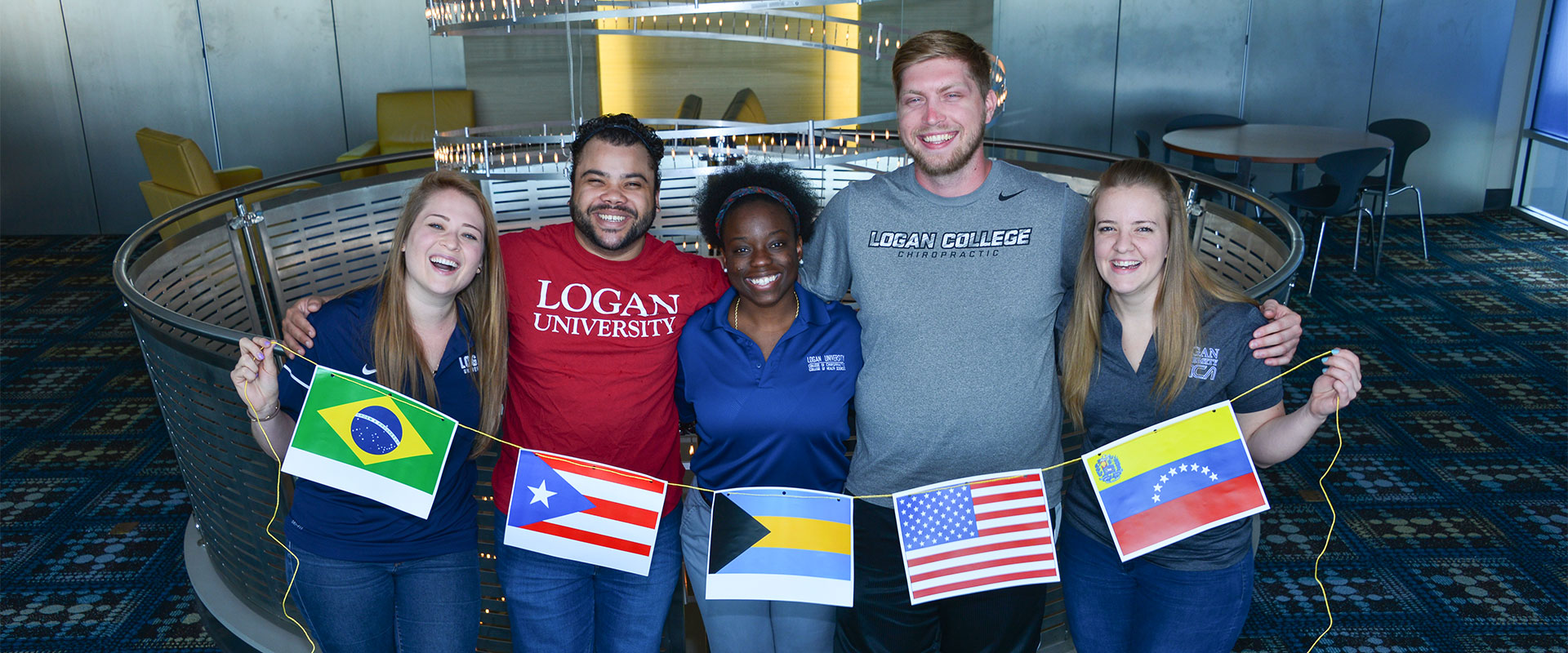 international-full-width Group of international students smiling and holding flags.