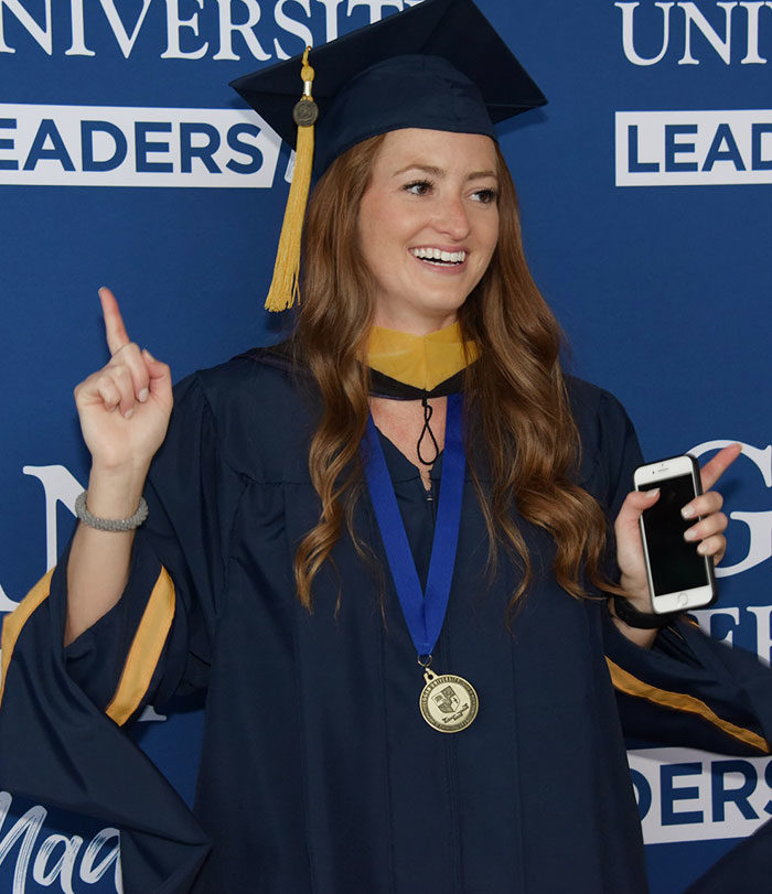 Female student smiling at graduation.