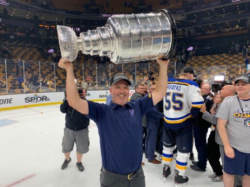 St. Louis Blues Team Chiropractor Dr. Mike Murphy Hoists the Stanley Cup on the Ice Following the Franchise's First Championship in June 2019