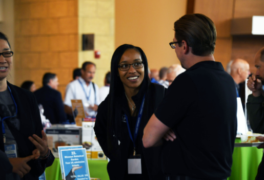 A woman and a man enjoy a conversation at Logan University Symposium